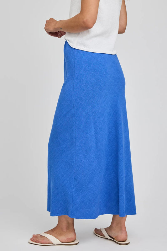 Jupe midi Britanny bleu vue de côté avec coupe légèrement évasée et tissu léger en rayonne et lin.