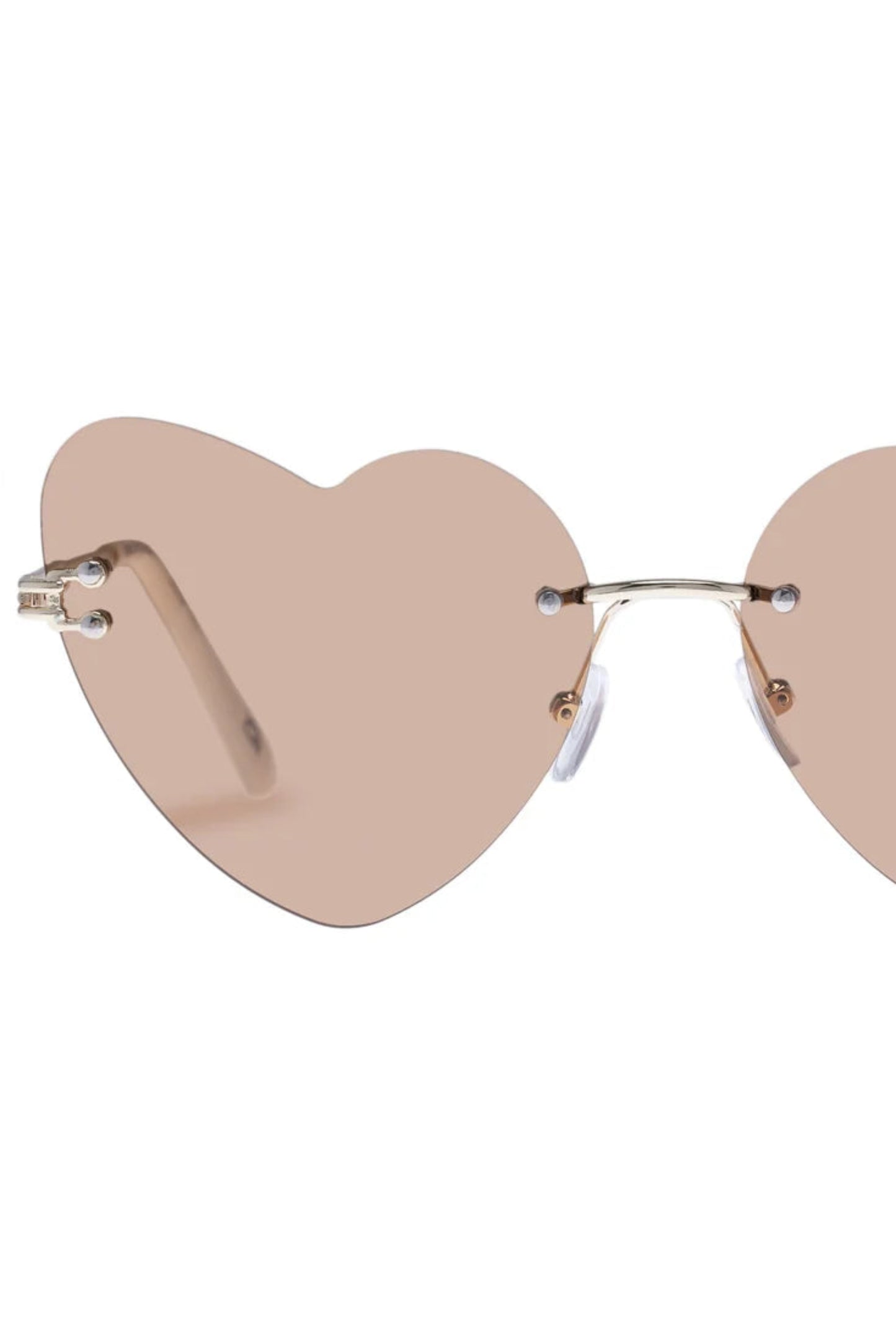 Vue rapprochée des lunettes de soleil Lucie Marbre Or avec design sans monture et verres beige.