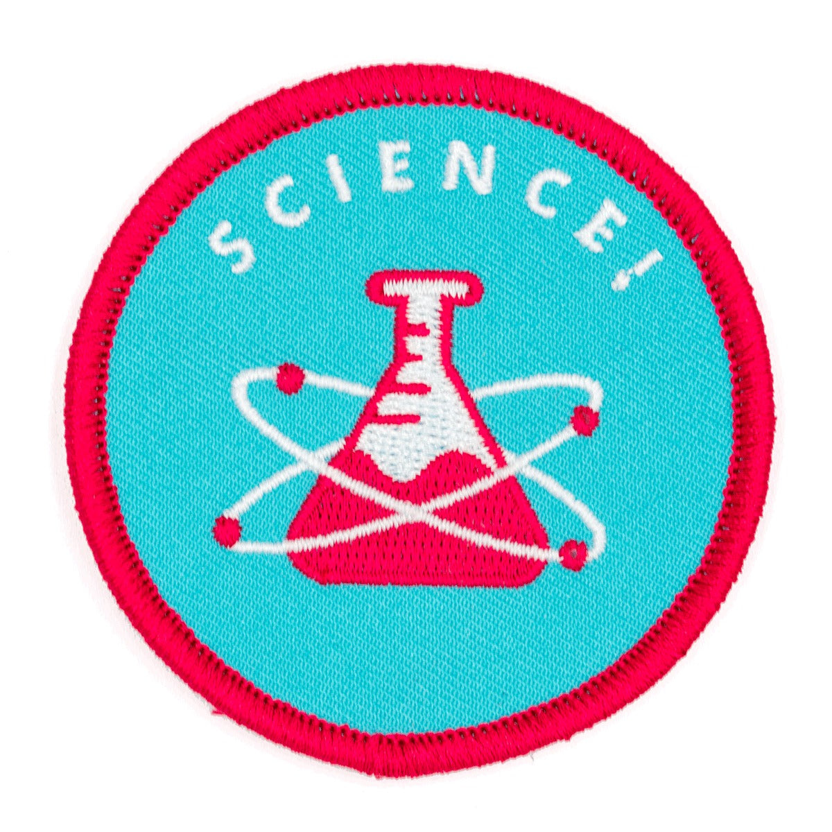 Patch rond sur lequel on peut voir une fiole rouge sur un fond bleu. Il y a un atome autour de la bouteille et le science est écrit au-dessus . Le fond est bleu et L’arrière-plan est un fond blanc.