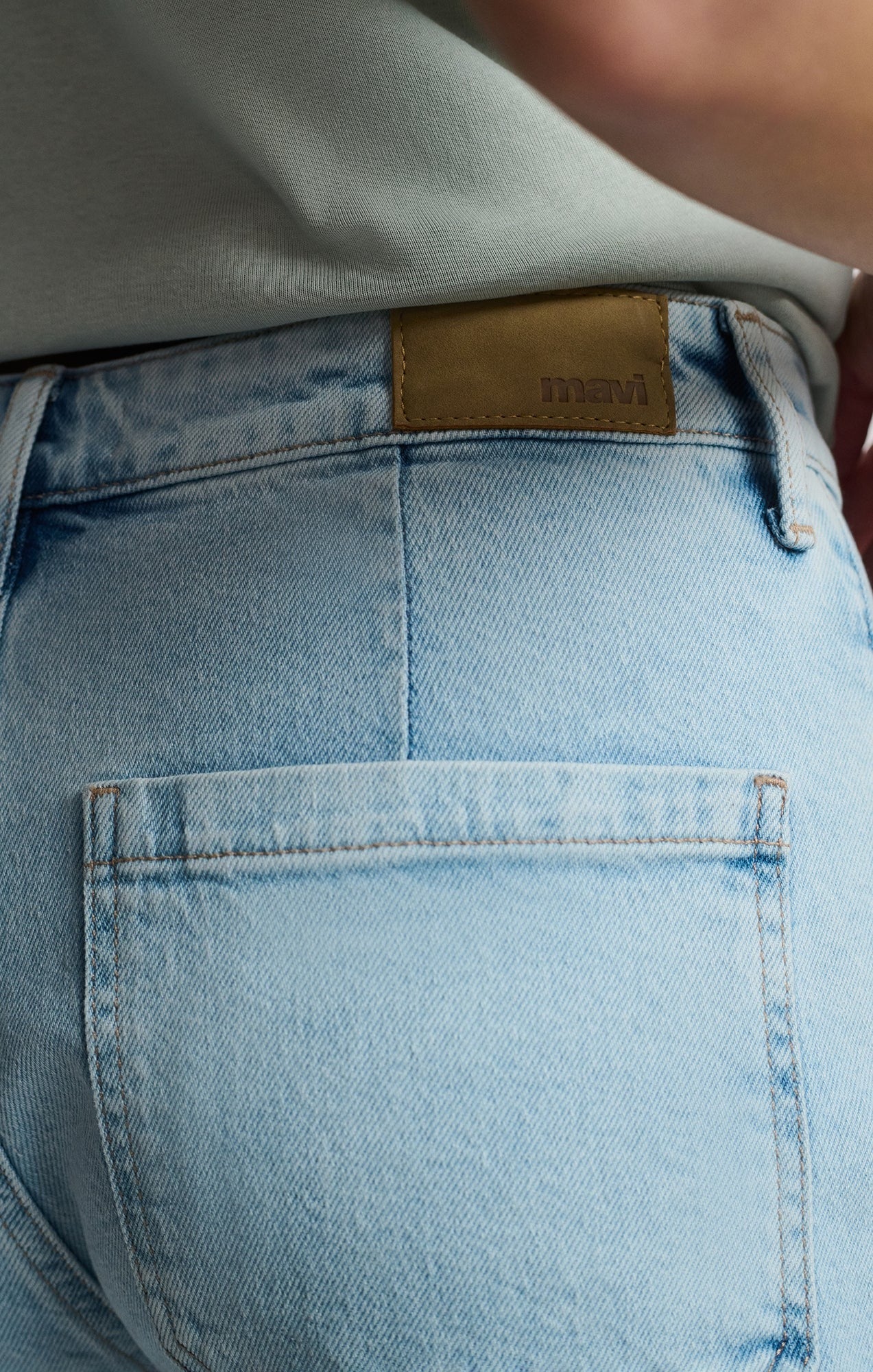 Détail du logo au dos du short en jeans bleu pâle – étiquette embossée