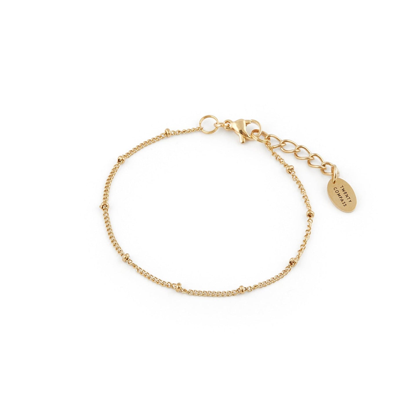 Bracelet doré très fin fait d'une chaîne sur laquelle se trouvent de petites perles aussi dorées intercalées à la même distance.
