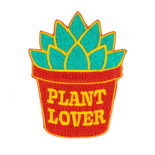 Patch en forme de succulente verte dans un pot rouge sur lequel est écrit en anglais Plant Lover. L’arrière-plan est un fond blanc. 