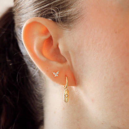 Boucles d’oreilles Elavyo plaquées or portées – créoles dorées avec pendentif étoile et zircon
