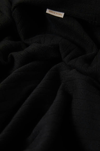 Gros plan sur le tissu pointelle noir Brixton – motif ajouré discret