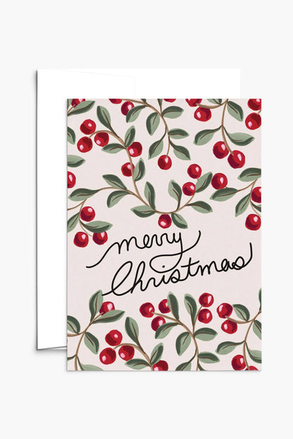 Carte Merry Christmas ouverte avec enveloppe blanche, motif baies rouges et feuillage festif