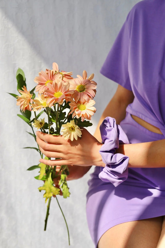 chouchou lilas porté au poignet avec robe assortie

