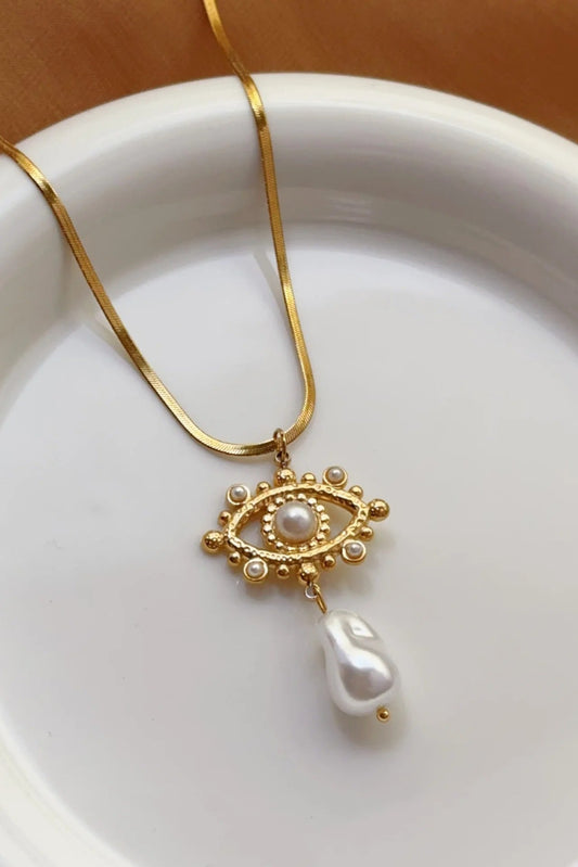 Collier Œil Perlé doré en acier inoxydable plaqué or avec pendentif orné de perles acryliques nacrées.