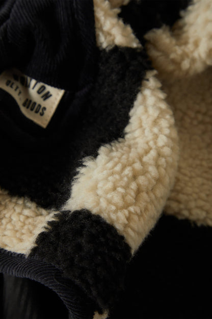 Tissu sherpa en damier noir et crème