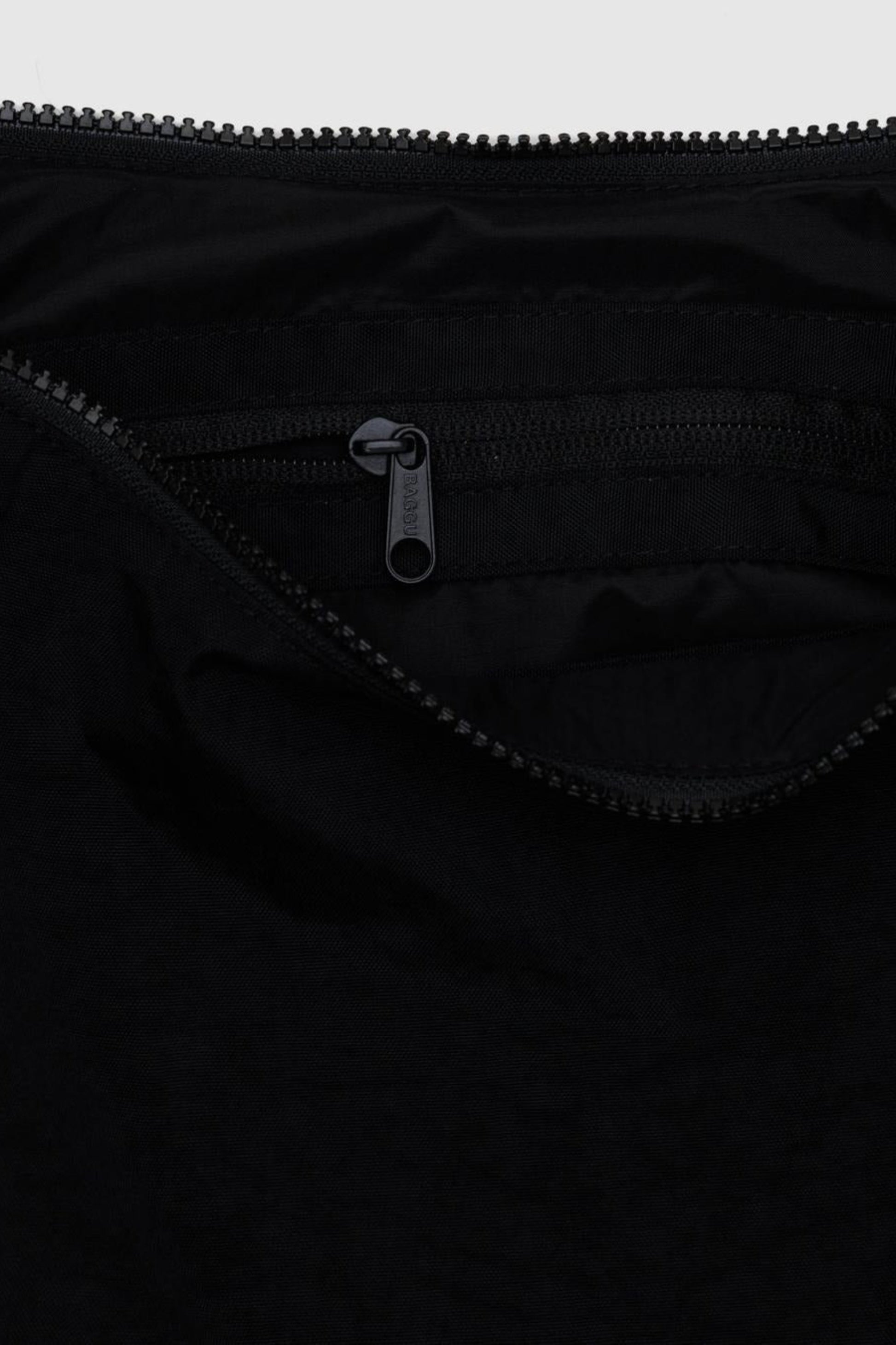 Vue intérieure du sac Croissant Moyen Noir avec poche zippée et porte-clés intégré