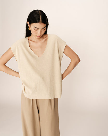 Zoom sur le col V du haut en maille lurex beige