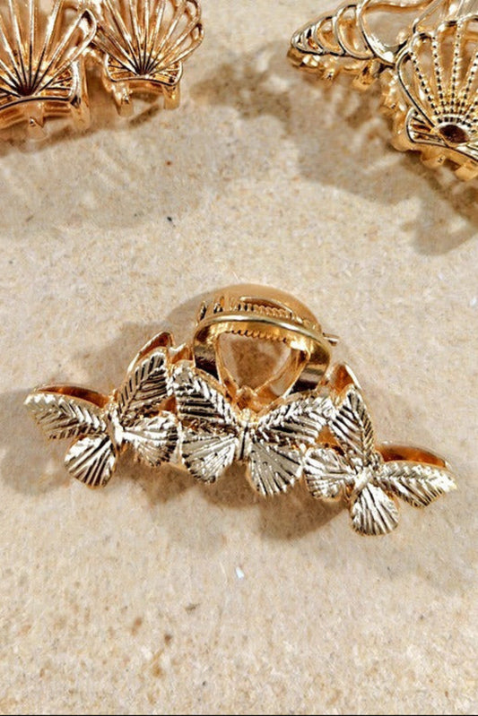 Pince a cheveux doree motif papillon portee dans les cheveux style chic et feminin