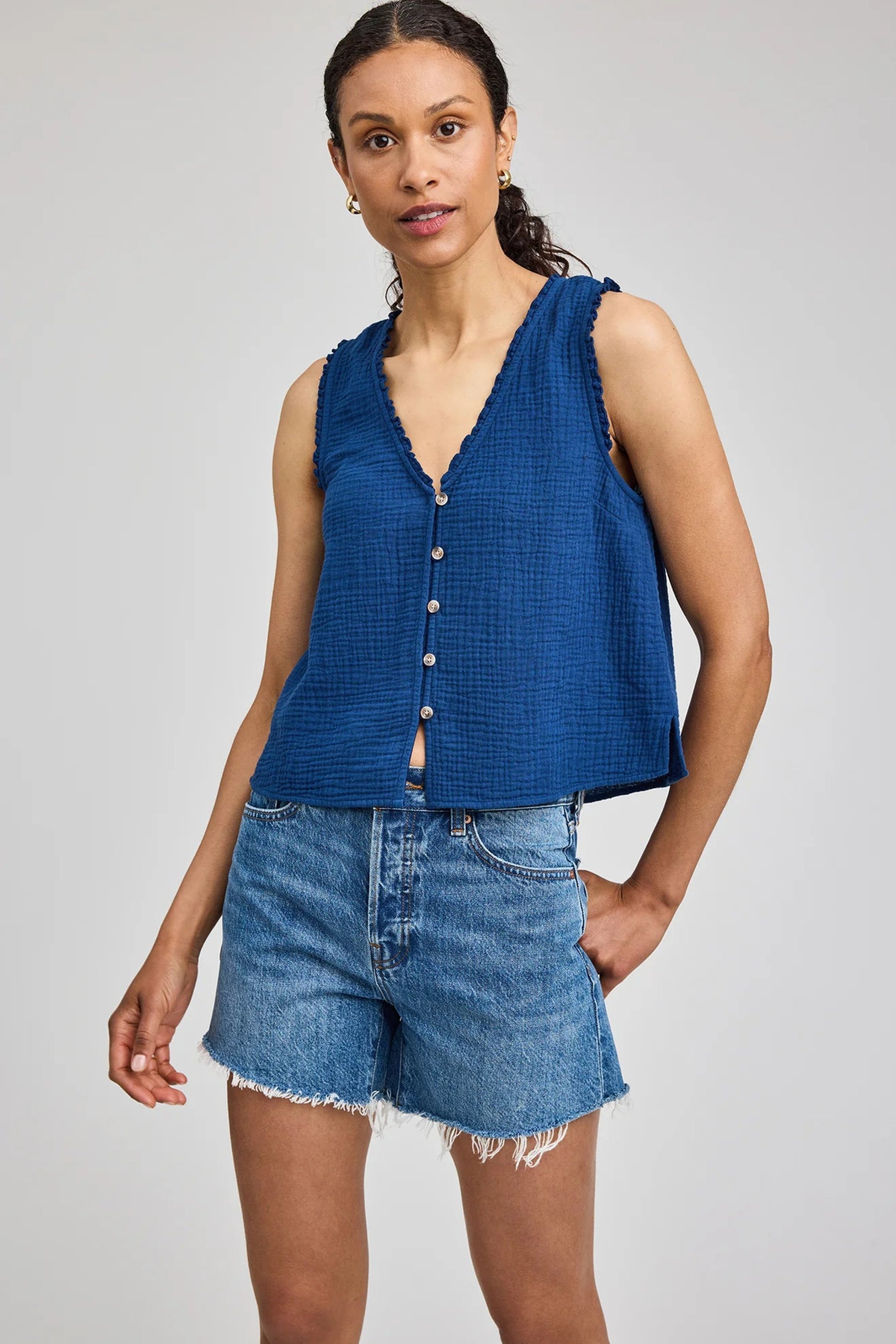 Détail du haut Penelope bleu avec boutons, bordure délicate et tissu texturé en double gaze de coton.