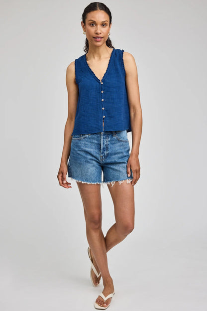 Haut sans manches Penelope bleu porté avec un short en jean pour un look estival décontracté.