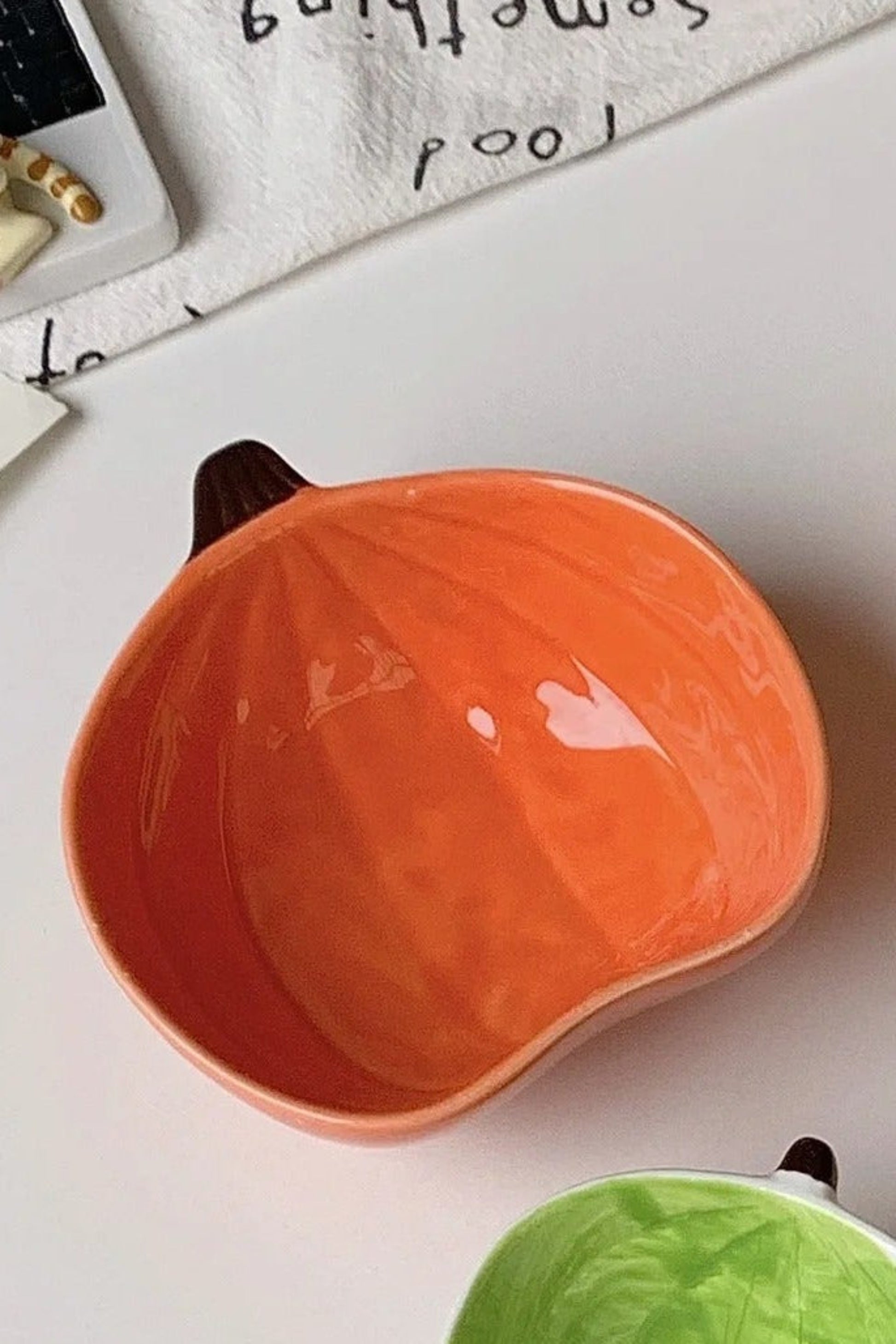 Petit plat en céramique en forme de citrouille orange, design ludique et décoratif