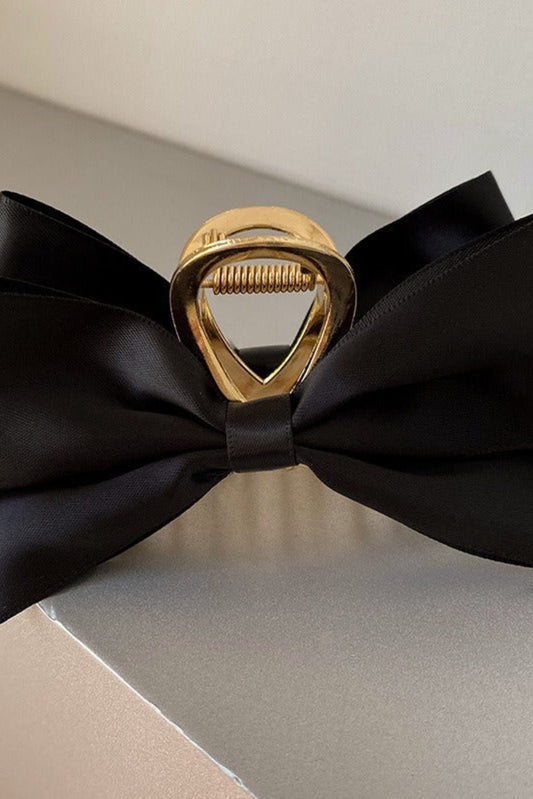 Pince à cheveux noire en satin avec attache métal doré et grand nœud volumineux