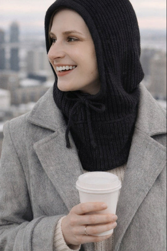 Capuche tricotée noire portée avec manteau d’hiver – doublure satin protectrice