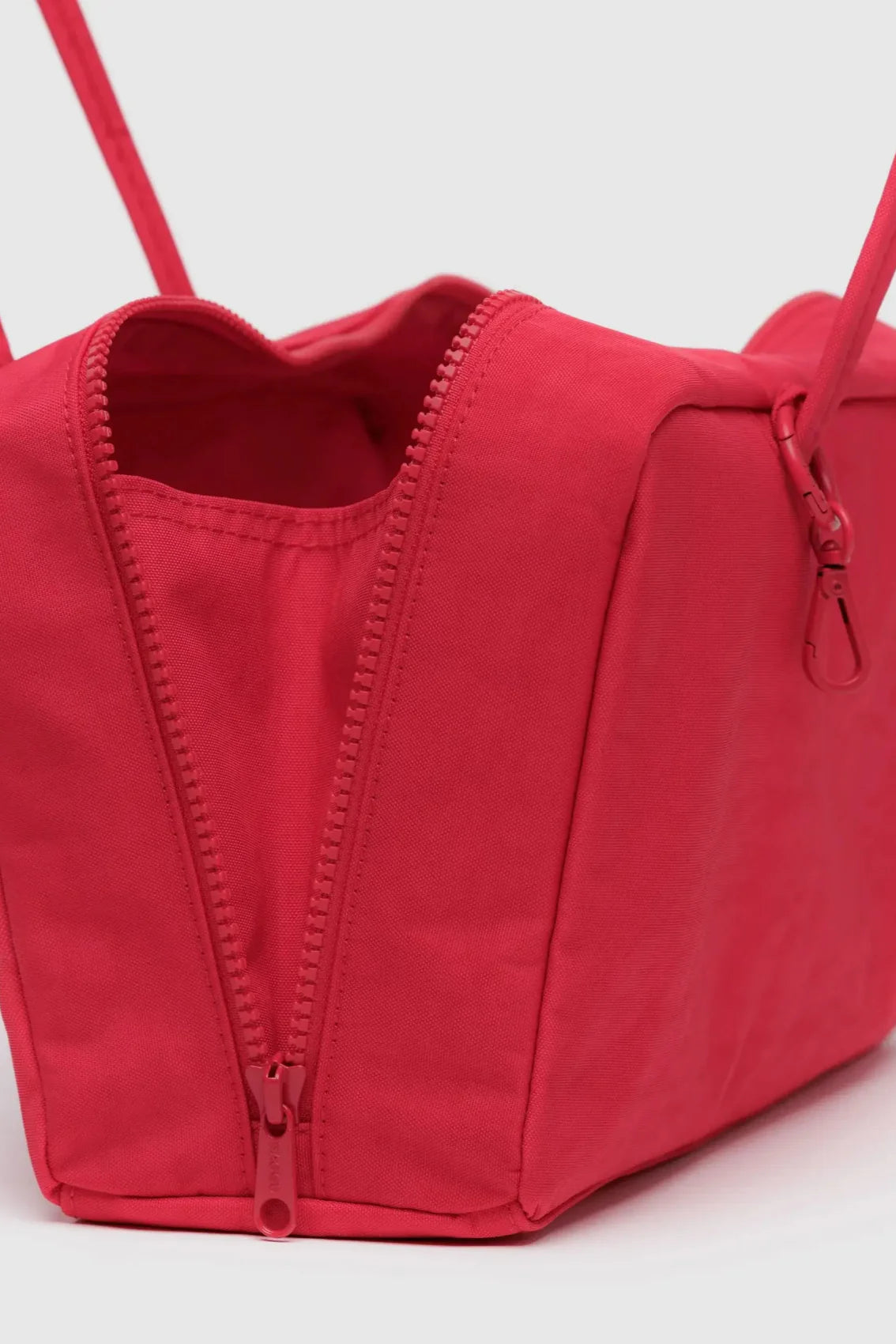 Zoom sur la fermeture zippée et l’intérieur du sac rouge – détails soignés